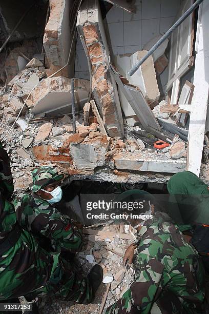 Indonesian Navy workers remove debris from the Gama English Course building site on October 2, 2009 in Padang, West Sumatera, Indonesia. According to...