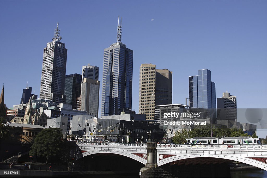 Melbourne city and moon in the blue sky