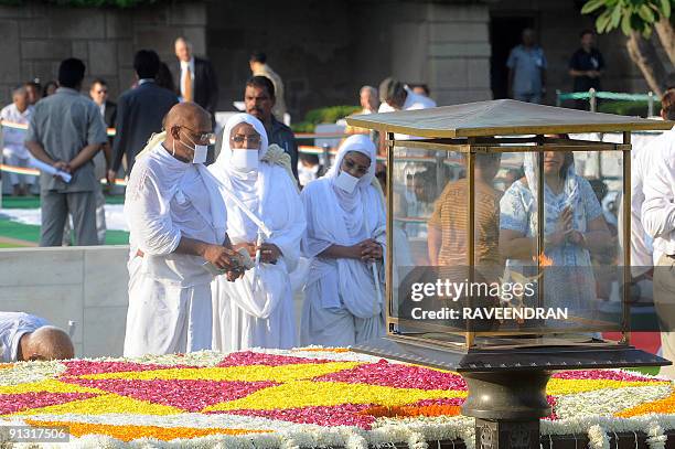 Jain monks and nuns pay their respects at the memorial to the Father of the Nation Mahatma Gandhi at Rajghat in New Delhi on October 2 in honour of...