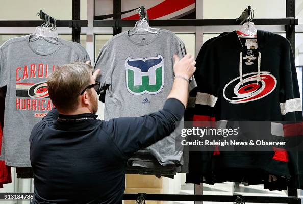 Kurt Cusac, a worker at The Eye store, straightens out the