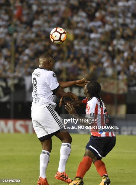 Colombia's Junior player Yimmi Chara vies for the ball with Paraguay's Olimpia player Mauricio Cuero during their Libertadores Cup football match at...