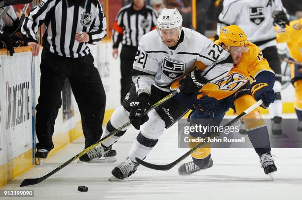 Craig Smith of the Nashville Predators battles for the puck against Trevor Lewis of the Los Angeles Kings during an NHL game at Bridgestone Arena on...