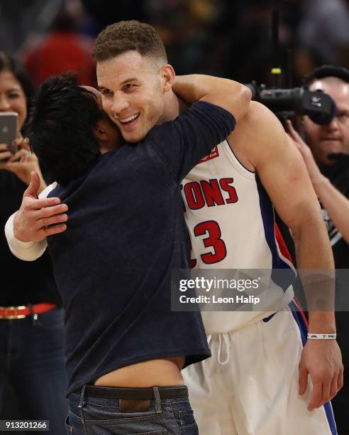 Detroit Pistons owner Tom Gores celebrates with Blake Griffin of the Detroit Pistons after defeated the Memphis Grizzlies at Little Caesars Arena on...