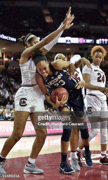 Connecticut's Azura Stevens corrals a rebound against South Carolina's A'ja Wilson and Alexis Jennings in the second half at Colonial Life Arena in...