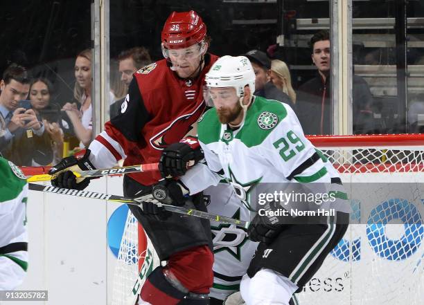 Christian Fischer of the Arizona Coyotes and Greg Pateryn of the Dallas Stars battle for the puck in front of goalie Kari Lehtonen of the Stars...