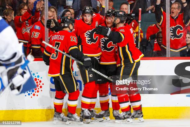 Teammates of the Calgary Flames celebrate in an NHL game on February 1, 2018 at the Scotiabank Saddledome in Calgary, Alberta, Canada.