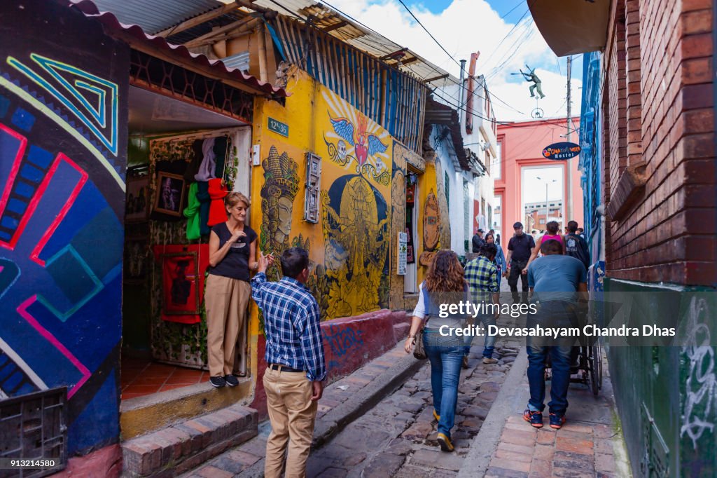 Bogotá, Colombia - Local Colombians On The Cobblestoned Calle del Embudo, In The Historic La Candelaria District of The Andean Capital City