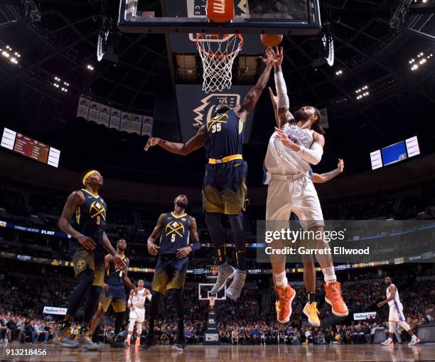 Kenneth Faried of the Denver Nuggets and Steven Adams of the Oklahoma City Thunder jump for the rebound on February 1, 2018 at the Pepsi Center in...