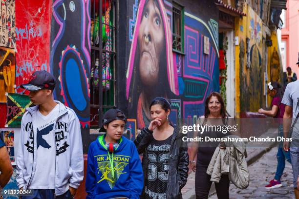 bogotá, colombia - local colombians on the cobblestoned calle del embudo, in the historic la candelaria district of the andean capital city - embudo stock pictures, royalty-free photos & images