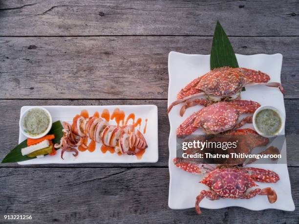 steam crabs and grilled octopus on wooden table - greek chef stock pictures, royalty-free photos & images