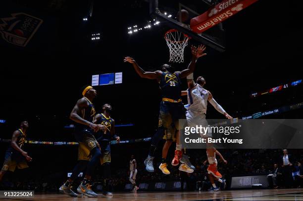 Kenneth Faried of the Denver Nuggets and Steven Adams of the Oklahoma City Thunder jump for the rebound on February 1, 2018 at the Pepsi Center in...