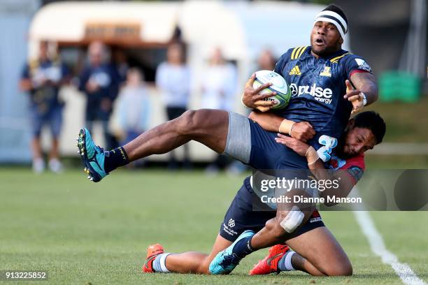 Tevita Nabura of the Highlanders is tackled by Curtis Rona of the Waratahs during the Super Rugby pre-season match between the Highlanders and the...
