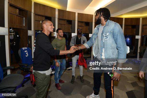 Soccer player Juan Agudelo shakes hands with DeAndre Jordan of the LA Clippers in the locker room before the game against the Boston Celtics on...