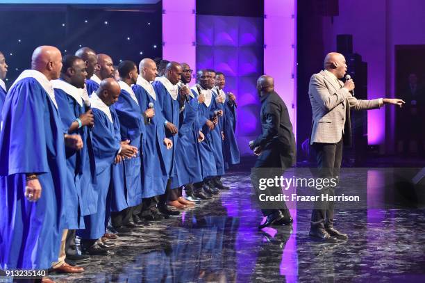 Donnie McClurkin performs with Members of the NFL Players Choir onstage during BET Presents 19th Annual Super Bowl Gospel Celebration at Bethel...