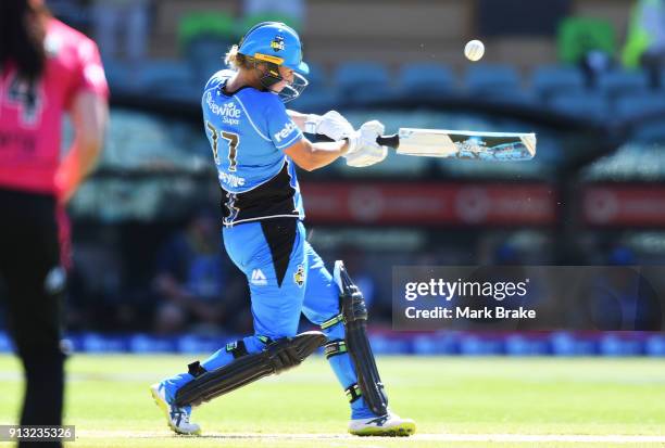 Sophie Devine of the Adelaide Strikers hits and is caught by Kim Garth of the Sydney Sixers during the Women's Big Bash League match between the...