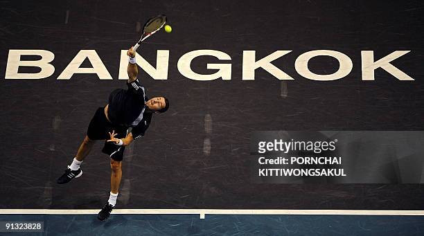 Marat Safin of Russia serves to Swiss player Macro Chiudinelli during their second round ATP Thailand Open tennis match in Bangkok on October 1,...