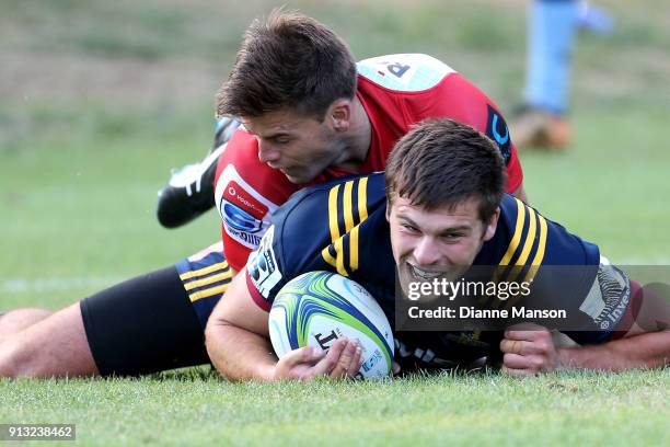 Dillon Hunt of the Highlanders scores a try during the Super Rugby pre-season match between the Highlanders and the Waratahs on February 2, 2018 in...