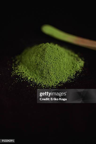 heap of powdered green tea and teaspoon - powder tea stock pictures, royalty-free photos & images