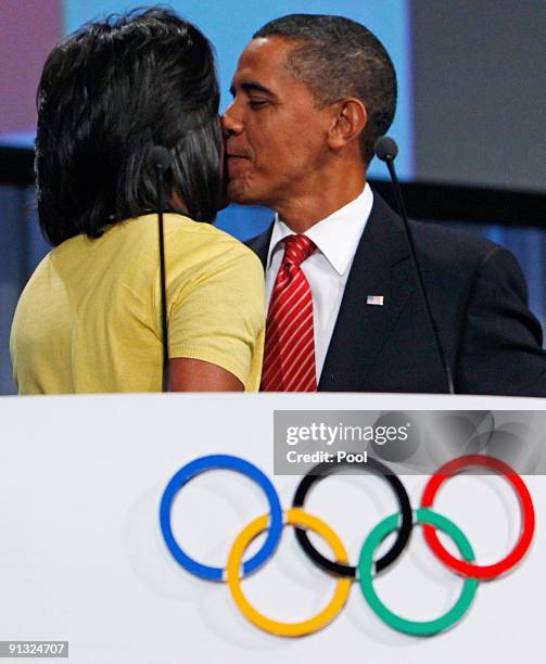 President Barack Obama kisses his wife the U.S. First lady Michelle Obama after she made an address during the Chicago 2016 bid presentation on...