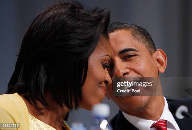 President Barack Obama speaks with first lady Michelle Obama after he made a presentation in support of Chicago as the host city for the 2016 Summer...