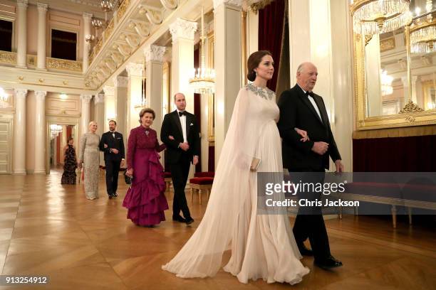 Catherine, Duchess of Cambridge is escorted into dinner by King Harald V of Norway and Prince William, Duke of Cambridge is escorted by Queen Sonja...