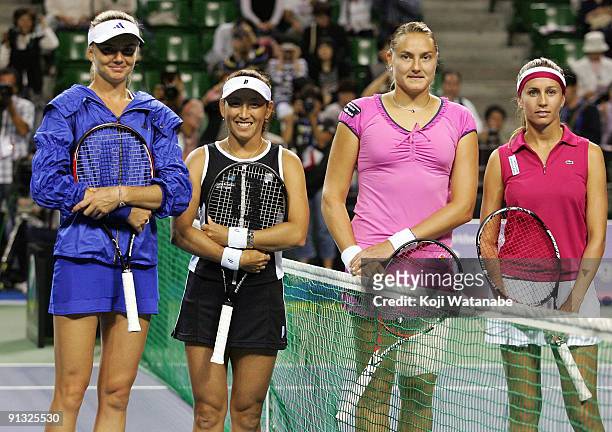 Daniela Hantuchova of Slovakia and Ai Sugiyama of Japan and Nadia Petrova of Russia and Gisela Dulko of Argentina pose before their doubles match...