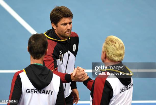 Boris Becker of Germany celebrates with team captain Michael Kohlmann after Alexander Zverev of Germany defeats Alex de Minaur of Australia during...