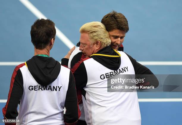 Boris Becker of Germany celebrates with team captain Michael Kohlmann after Alexander Zverev of Germany defeats Alex de Minaur of Australia during...