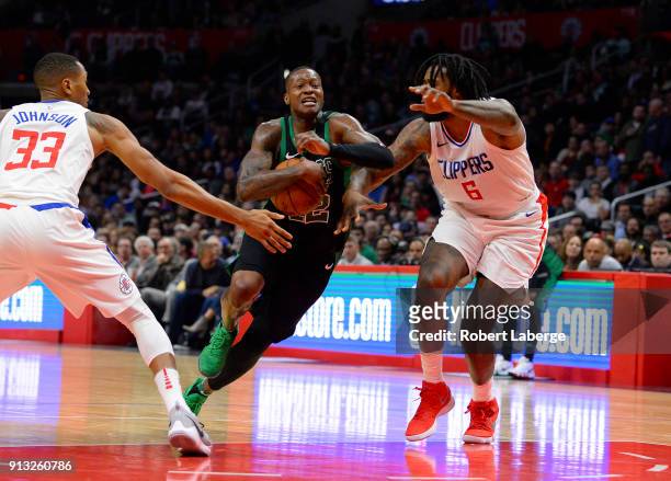 Terry Rozier of the Boston Celtics plays against Wesley Johnson and DeAndre Jordan of the Los Angeles Clippers on January 24, 2018 at STAPLES Center...