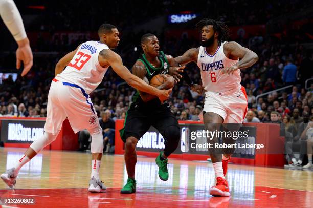 Terry Rozier of the Boston Celtics plays against Wesley Johnson and DeAndre Jordan of the Los Angeles Clippers on January 24, 2018 at STAPLES Center...