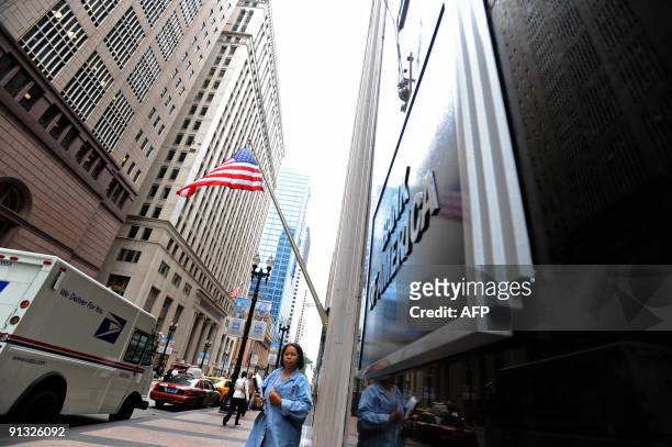 Woman walks by the Bank of America in Chicago, Illinois on September 15, 2008. Bank of America announced Monday it was buying Merrill Lynch for 50...