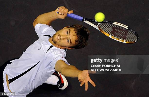 Swiss player Macro Chiudinelli serves to Marat Safin of Russia during their second round ATP Thailand Open tennis match in Bangkok on October 01,...