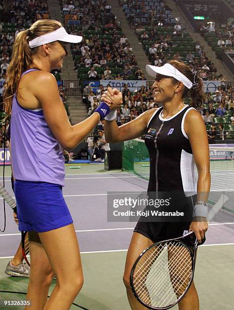 Ai Sugiyama of Japan and Daniela Hantuchova of Slovakia celebrate after their win over Nadia Petrova of Russia and Gisela Dulko of Argentina during...