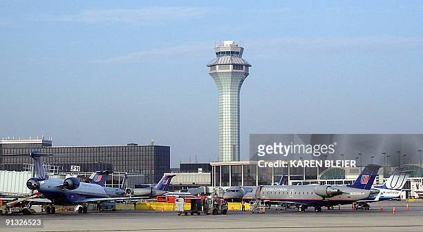 This photo shows United Airlines aircraft sitting 08 November 2005, at the terminal near the air traffic control tower at O'Hare International...