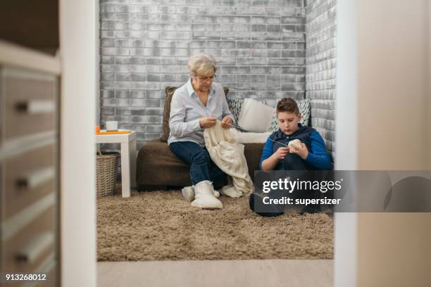 senior woman is knitting sweather - old granny knitting stock pictures, royalty-free photos & images