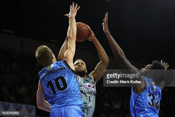 Demitrius Conger of the Hawks shoots under pressure from Tom Abercrombie and Rakeem Christmas of the Breakers during the round 17 NBL match between...