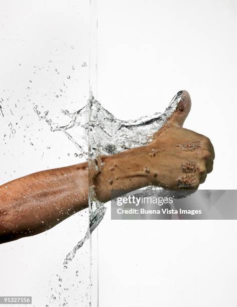 thumb through a water wall - auftauchen wasser stock-fotos und bilder