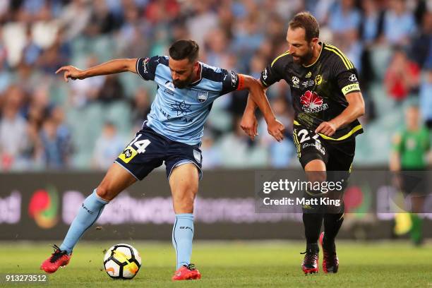 Alex Brosque of Sydney FC is challenged by Andrew Durante of Wellington Phoenix during the round 19 A-League match between Sydney FC and the...