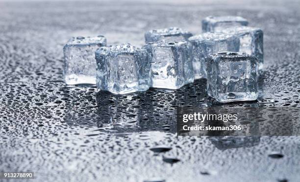 ice cube inside whisky glass on wet background - whiskey tasting stock pictures, royalty-free photos & images