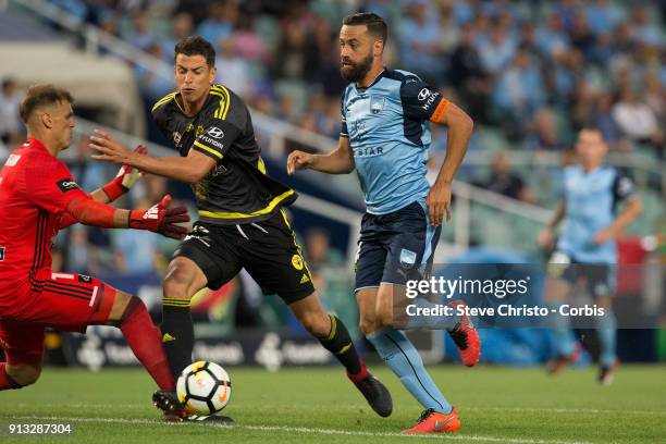 Alex Brosque of Sydney FC gets past Wellington's Lewis Italiano and Scott Galloway to score during the round 19 A-League match between Sydney FC and...