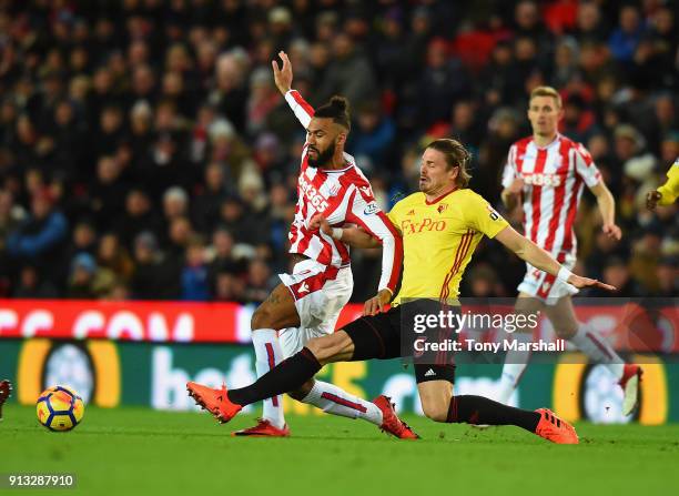 Maxim Choupo-Moting of Stoke City is tackled by Sebastian Prodl of Watford during the Premier League match between Stoke City and Watford at Bet365...