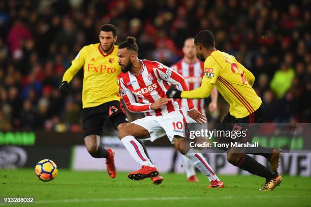 Maxim Choupo-Moting of Stoke City gets between Etienne Capoue and Christian Kabasele of Watford during the Premier League match between Stoke City...