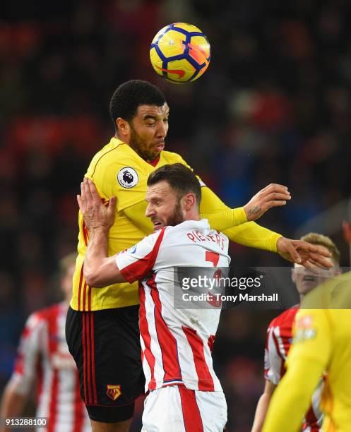 Erik Pieters of Stoke City challenges Troy Deeney of Watford during the Premier League match between Stoke City and Watford at Bet365 Stadium on...