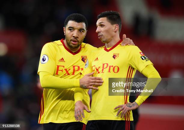 Troy Deeney and Jose Holebas of Watford during the Premier League match between Stoke City and Watford at Bet365 Stadium on January 31, 2018 in Stoke...