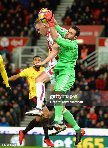 Orestis Karnezis of Watford makes a save from Ryan Shawcross of Stoke City during the Premier League match between Stoke City and Watford at Bet365...