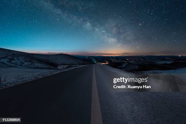 starry night with empty windy road - country road night stock pictures, royalty-free photos & images