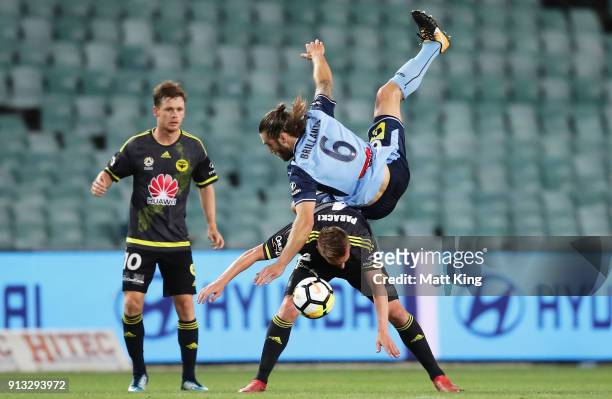 Joshua Brillante of Sydney FC collides with Goran Paracki of Wellington Phoenix during the round 19 A-League match between Sydney FC and the...