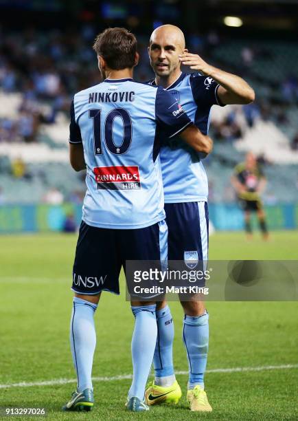 Milos Ninkovic of Sydney FC celebrates with Adrian Mierzejewski after scoring a goal during the round 19 A-League match between Sydney FC and the...