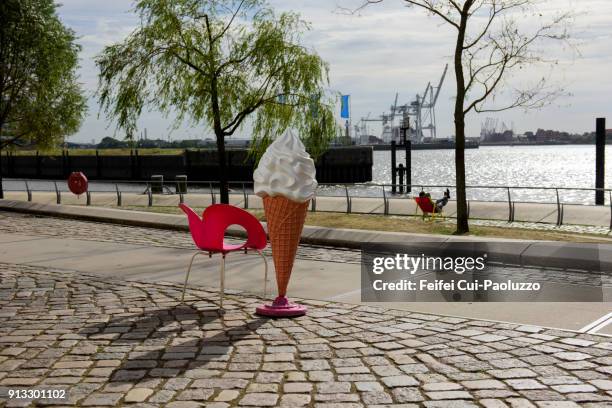 a red chair and an ice cream cone model at hamburg, germany - fußgängerzone stock-fotos und bilder