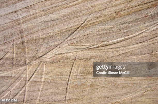 gorged sandstone block in an exterior wall - sandstone wall stock pictures, royalty-free photos & images